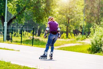 Girl roller skating in the summer Park
