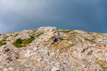 Top of the mountain close-up on a background of summer sky