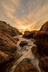 Fototapeta na wymiar Sunrise between the rocks of the renega in Oropesa