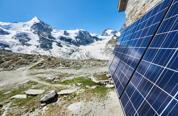 Close-up perspective snapshot of solar modules installed on the walls of alpine hut in Swiss Alps...