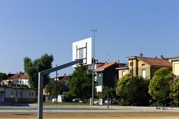 Basketball hoop on a playground in a sunny day (Pesaro, Italy, Europe)