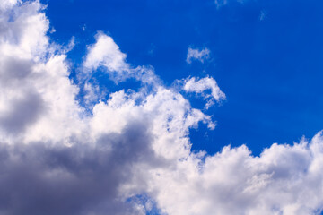 Bright cumulus clouds against the blue sky. Sunset sky Natural background.