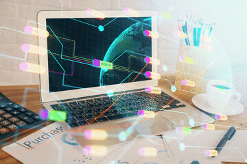 Double exposure of desktop with computer and world map hologram. International data network concept.