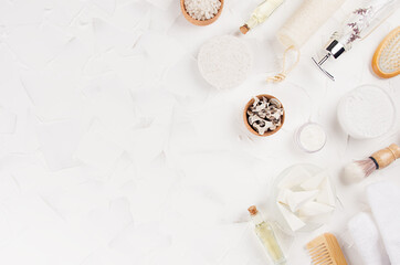Gentle natural beige beauty products and accessories for bathing  on soft light white background, flat lay, copy space, border.