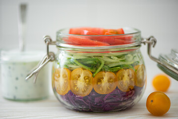 vegetable salad of tomato, cabbage and cucumbers in a jar