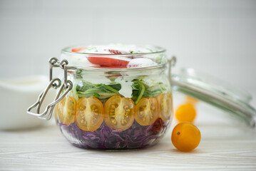 vegetable salad of tomato, cabbage and cucumbers in a jar