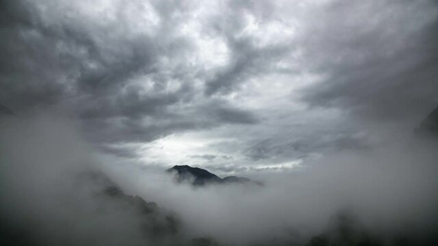 Aerial View over Mountain Peak in Storm Clouds in Ticino, Switzerland.