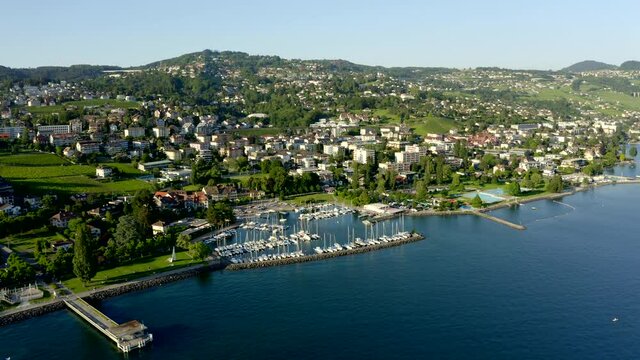 Lateral Aerial View Of The Stunning Port De Pully In Lavaux, Switzerland On A Sunny Day - aerial cartwheel shot