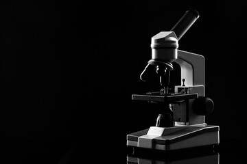 laboratory microscope on table in the dark