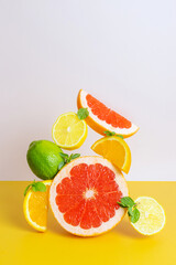 Creative bright composition of orange, grapefruit, lime and lemon. The concept of citrus, summer, vitamin healthy food, vegetarianism.