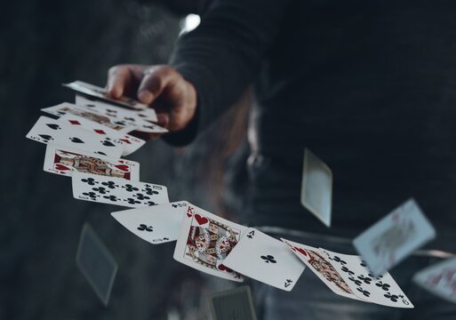 Man throwing the white various cards in the air