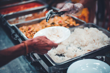 The hands of the poor have been begging to donate food from the donor : the concept of feeding