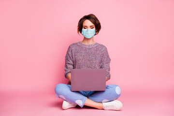 Portrait of her she nice pretty girl wearing gauze mask using laptop sitting in lotus pose mers cov...