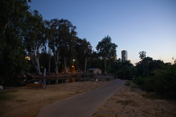 Ha-Yarkon park river and Ramat Gan business buildings on the background at evening, Tel Aviv, Israel.