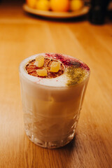 Sweet Famous white with caramels decoration slice  Author inspired Cocktail Drink - on bar counter . Close-up Top view . Copy paste space for design people and luxury service barman in nightclub