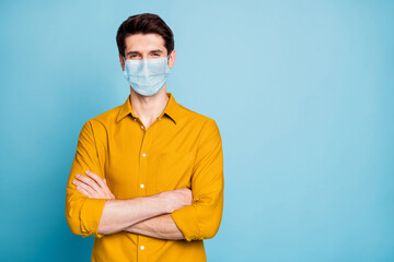 Portrait of his he nice attractive content guy hands folded wearing safety gauze mask copy space hygiene health care medicine stop influenza flue isolated over pastel blue color background