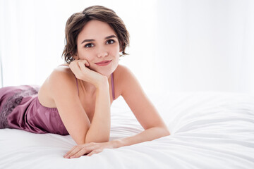 Obraz na płótnie Canvas Close-up portrait of her she nice attractive charming pretty cute cheery sweet brown-haired girl wearing silk resting lying on bed waiting boyfriend in light white style interior house apartment flat