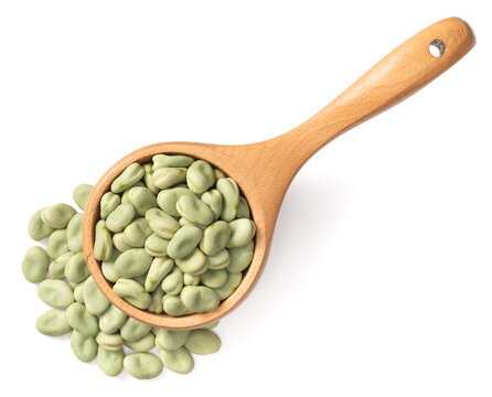 dried green broad beans in the wooden spoon, isolated on white background, top view