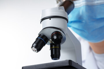 Close up photo of woman scientist working with microscope