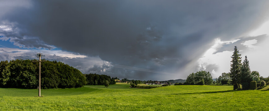gloomy thunderclouds over a rural area with meadows and forest in the Baden Allg&auml;u near Wolfegg
