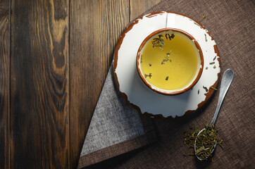 Obraz na płótnie Canvas Green tea mug top view, cane brown sugar with space for text. Pleasant tea party in the evening