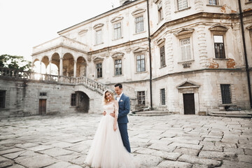 Obraz premium Romantic wedding moment, couple of newlyweds smiling portrait, bride and groom hugging