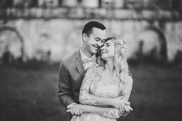 Gorgeous happy couple standing close to each other and looking in eyes