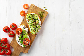 Sandwiches with cheese feta, cucumber slices and cherry tomatoes. View from above