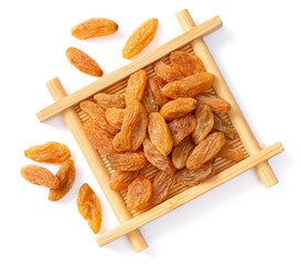 yellow raisins in the bamboo plate, isolated on white background, top view