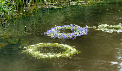 Obraz na płótnie Canvas Wreaths of flowers floating on the water