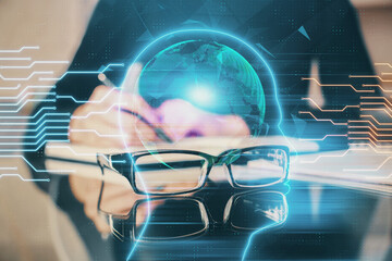 Double exposure of writing hand on background with brain hologram. Concept of learning.