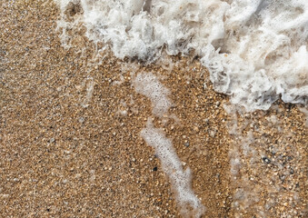 Texture of foamy bubbling large sea waves close-up.