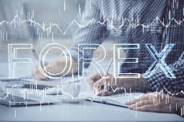 Multi exposure of forex chart with man working on computer on background. Concept of market analysis.