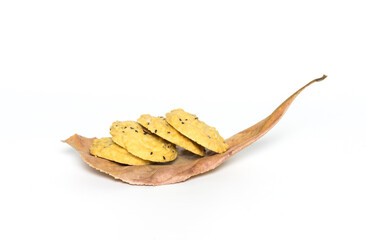 Group of cookies put on dry leaves and white background,selective focus.