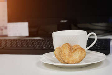Cookies heart shape and coffee cup on table,soft focus.