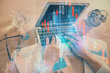 Multi exposure of forex graph with man working on computer on background. Concept of market analysis.