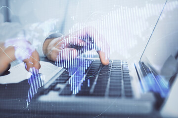 Multi exposure of businessman working on laptop on background. International business hologram in front. Concept of success.