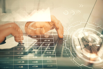 Double exposure of market chart with man working on computer on background. Concept of financial analysis.