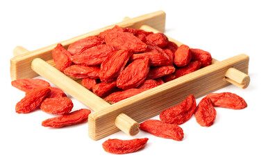 dried Chinese wolfberries in the bamboo plate, isolated on white background