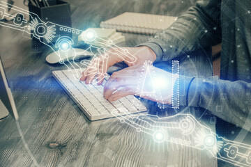 Fototapeta premium A man working on computer with technology theme drawing. Concept of big data. Multi exposure.