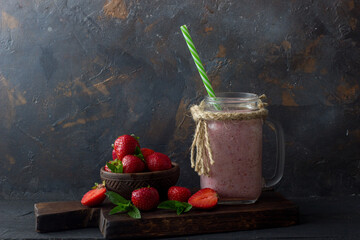 Strawberry smoothie or milkshake on black background