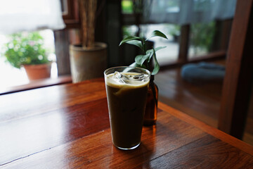 Close up glass of Iced Hojicha, Roasted Japanese green tea on wooden table