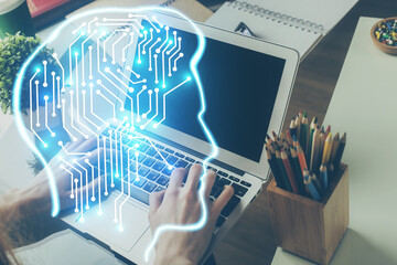 Businessman with computer background with brain theme hologram. Concept of brainstorm. Multi exposure.