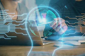 Businessman with computer background with brain theme hologram. Concept of brainstorm. Multi exposure.