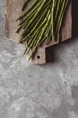 Asparagus on a cutting board. Healthy food, health on a concrete background.