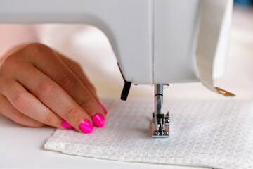 Woman seamstress working at textile factory close up