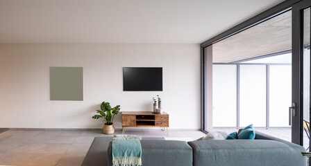 interior of a living room with a sofa seen from behind. On the wall a television, minimalist furniture