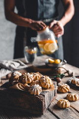 Man pours Hot tea with slices of fresh grapefruit on wooden tablet. Healthy drink, Eco, vegan.