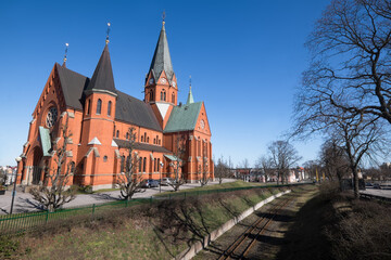 The Sankt Petri Kyrka or Saint Peter Church next to the metro line in  Västervik (Vastervik) in Sweden. Blue sky © Henk Vrieselaar