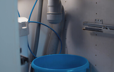 Water flowing from a syphon under the kitchen sink